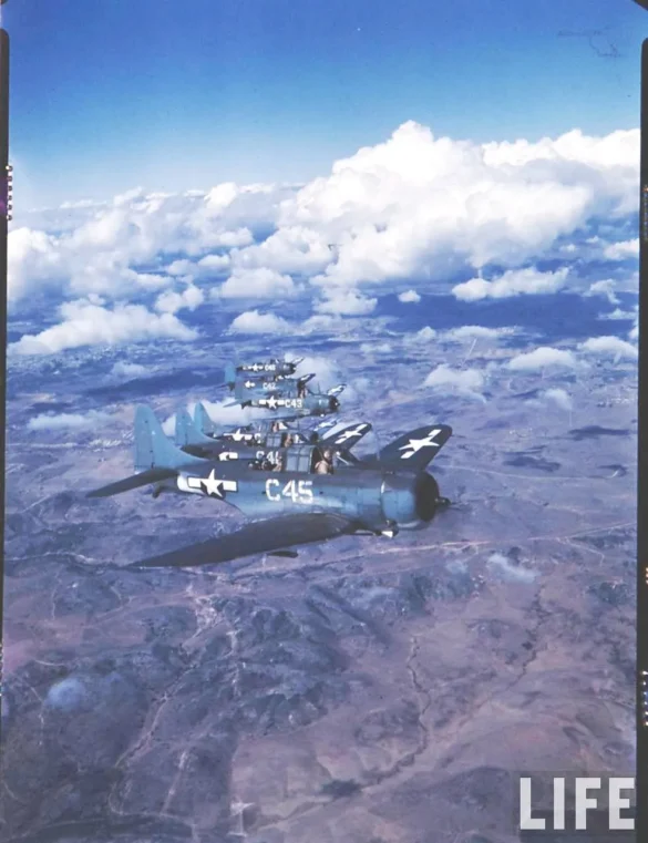 Weathered Douglas SBD Dauntless White C 46 showing faded Blue Gray camouflage and replacement cowling during a training flight.