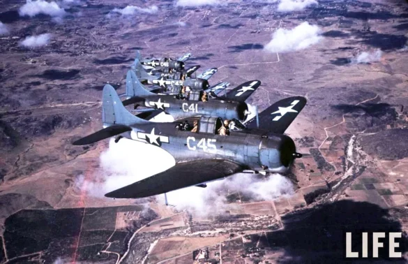 Weathered Douglas SBD Dauntless White C 46 showing faded Blue Gray camouflage and replacement cowling during a training flight.