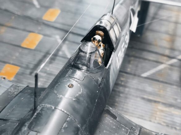 Detailed 1:48 scale F4U-1 Corsair Birdcage model representing VF-17 17-F-31, built with Tamiya, Aires, ICM and Eduard components and displayed on a U.S. Navy aircraft carrier deck.