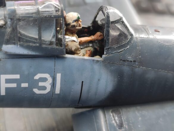 Detailed 1:48 scale F4U-1 Corsair Birdcage model representing VF-17 17-F-31, built with Tamiya, Aires, ICM and Eduard components and displayed on a U.S. Navy aircraft carrier deck.