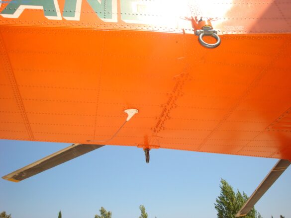 Firefighting water tank mounted beneath the fuselage of a Sikorsky S-64 Skycrane.