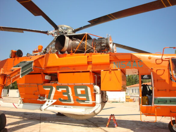Sikorsky S-64 Skycrane firefighting helicopter operating during wildfire suppression in Greece.