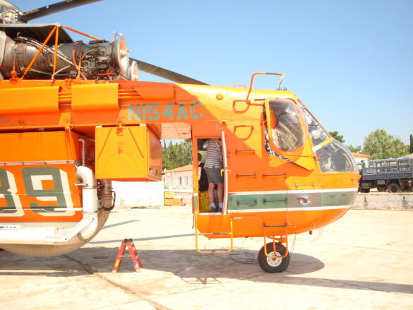 Sikorsky S-64 Skycrane firefighting helicopter operating during wildfire suppression in Greece.
