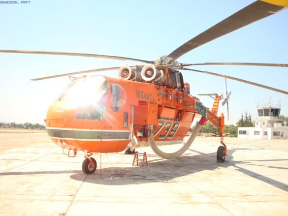 Sikorsky S-64 Skycrane collecting water using its firefighting snorkel.